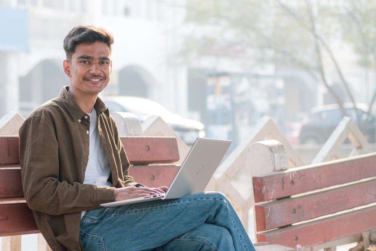 A young person in India studying on a laptop, starting a tech career